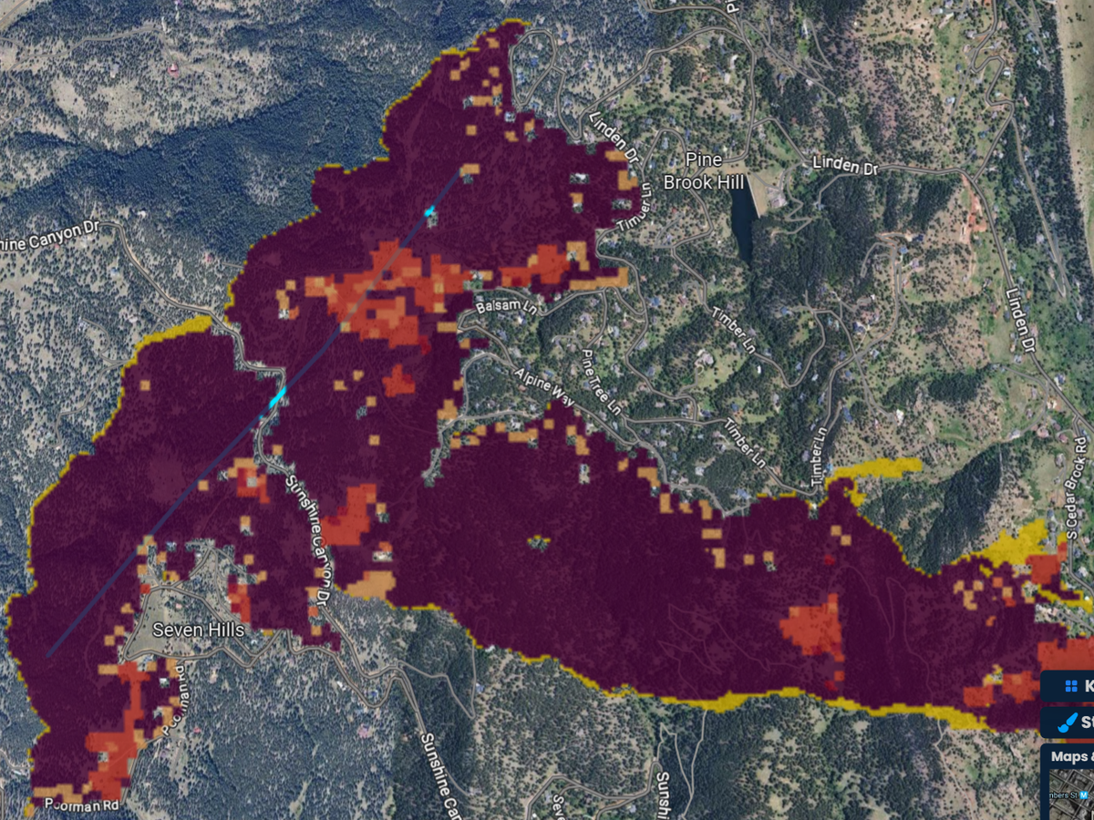 A fire started along a power line in Sunshine Canyon, Colorado, burning east in a 50 km/h west wind, with flames over 3.4 m and crown fire in the timber.